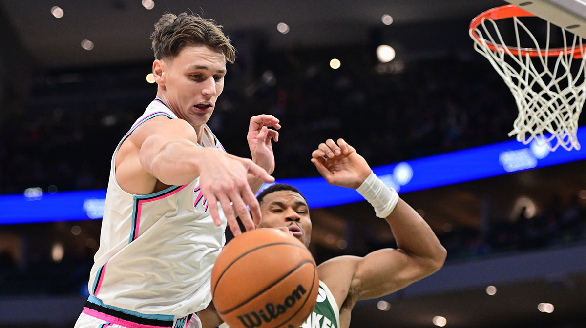 Miami Heat guard Pelle Larson (9) reaches for a rebound against Milwaukee Bucks forward Giannis Antetokounmpo (34) in the third quarter at Fiserv Forum. 