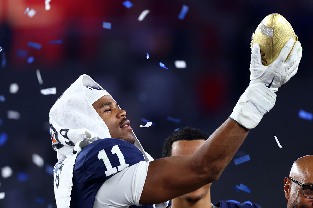 Penn State Nittany Lions defensive end Abdul Carter (11) reacts with the trophy after the game against the Boise State Broncos in the Fiesta Bowl at State Farm Stadium.