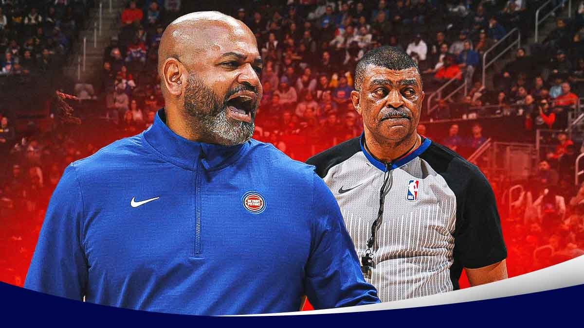 (Pistons) JB Bickerstaff next to an NBA ref on the Hornets' court