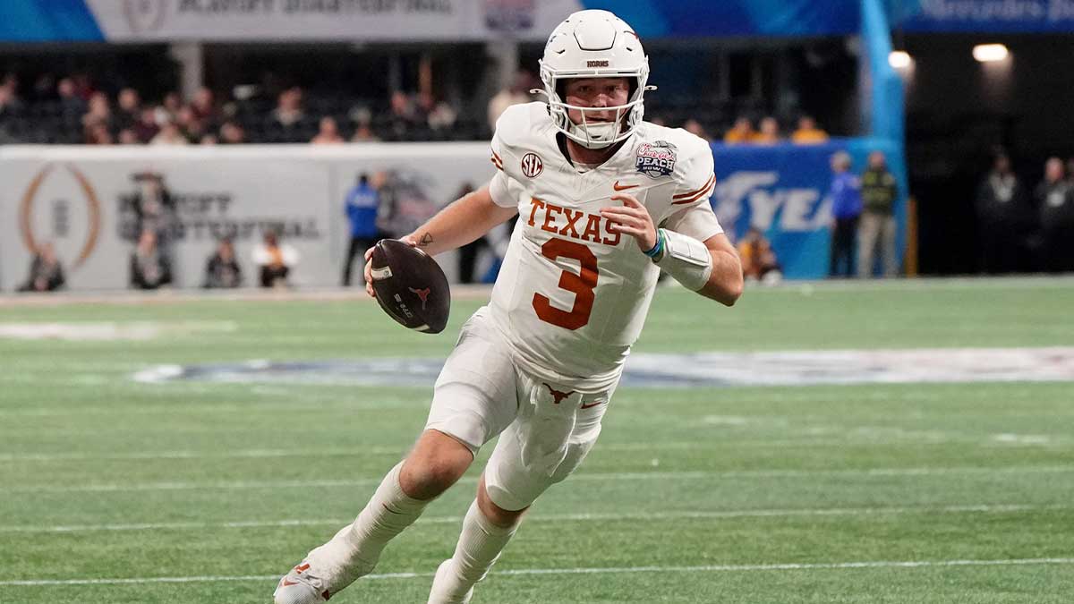 Jan 1, 2025; Atlanta, GA, USA; Texas Longhorns quarterback Quinn Ewers (3) runs with the ball for a touchdown against the Arizona State Sun Devils during the second half of the Peach Bowl at Mercedes-Benz Stadium. Mandatory Credit: Dale Zanine-Imagn Images