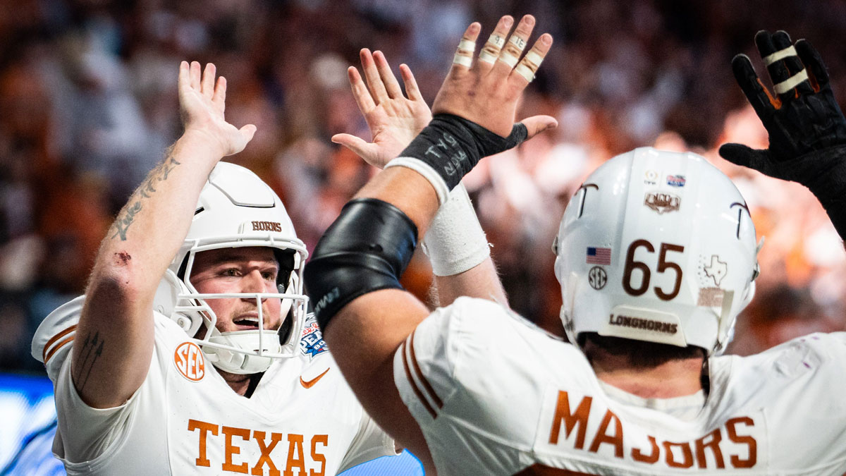 Texas Longhorns quarterback Quinn Ewers (3) celebrates with Texas Longhorns offensive lineman Jake Majors (65) after scoring a touchdown in the fourth quarter as the Texas Longhorns play the Arizona State Sun Devils in the Peach Bowl College Football Playoff quarterfinal at Mercedes-Benz Stadium