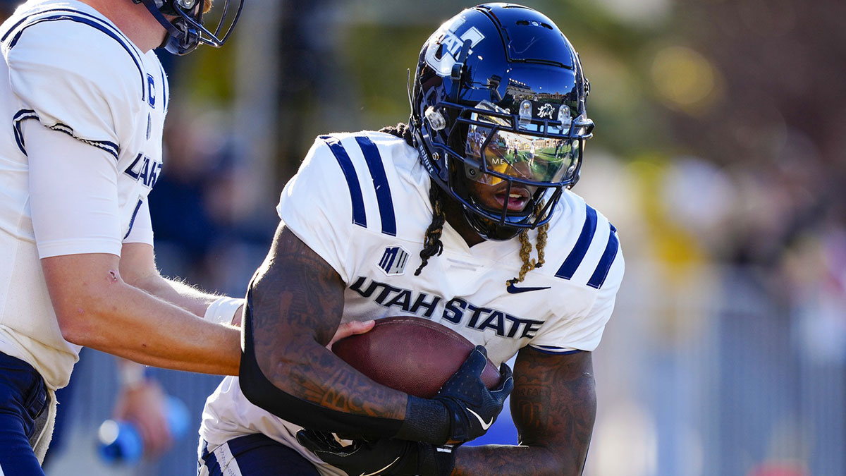 Utah State Aggies running back Rahsul Faison (3) warms up before the game against the Wyoming Cowboys at Jonah Field at War Memorial Stadium.