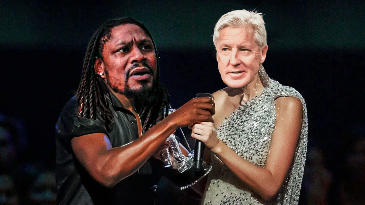 Former Raiders RB Marshawn Lynch grabbing microphone from Raiders HC Pete Carroll.