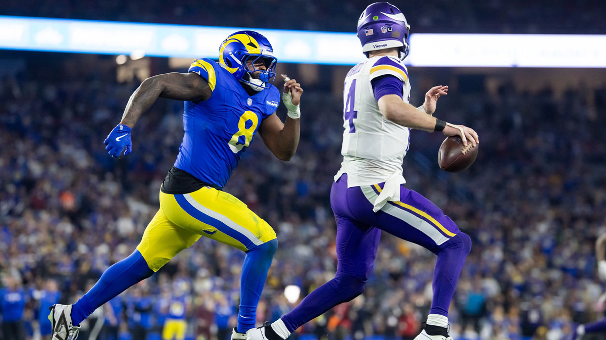 Minnesota Vikings quarterback Sam Darnold (14) is chased by Los Angeles Rams tight end Jared Vers (8) during the NFC wild card game at State Farm Stadium. Mandatory Credit: Mark J. Rebilas-Imagn Images