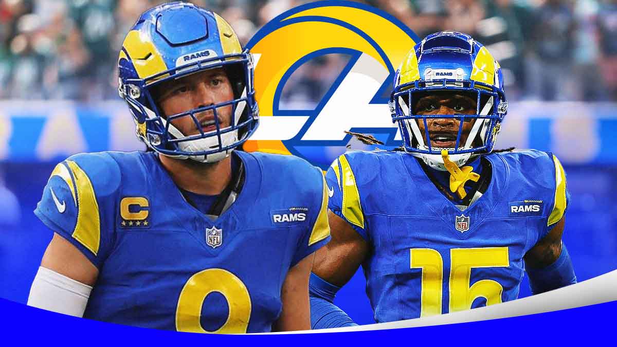 Los Angeles Rams QB Matthew Stafford looking sad/distraught next to WR Demarcus Robinson. Rams logo in background. Background is Statefarm Stadium.