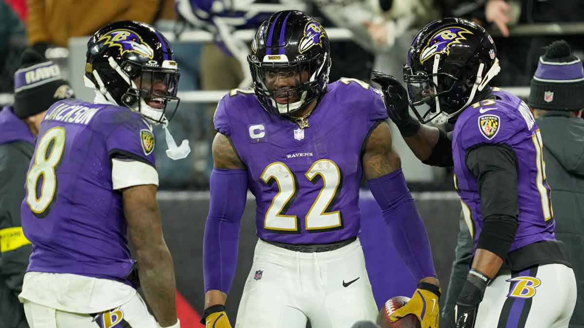 Baltimore Ravens running back Derrick Henry (22) celebrates with wide receiver Nelson Agholor (15) and quarterback Lamar Jackson (8) after scoring a touchdown against the Pittsburgh Steelers in the third quarter in an AFC wild card game at M&T Bank Stadium.