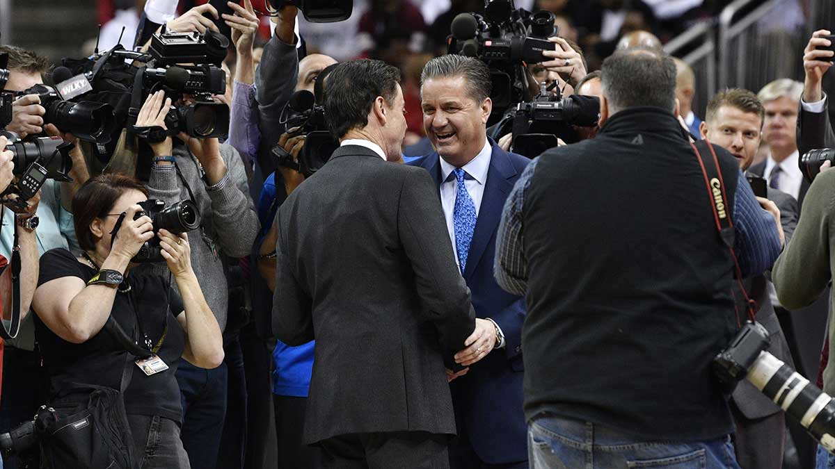 Louisville Cardinals head coach Rick Pitino shakes the hands with Kentucky Wildcats head coach John Calipari before the first half at KFC Yum! Center. Louisville defeated Kentucky 73-70.