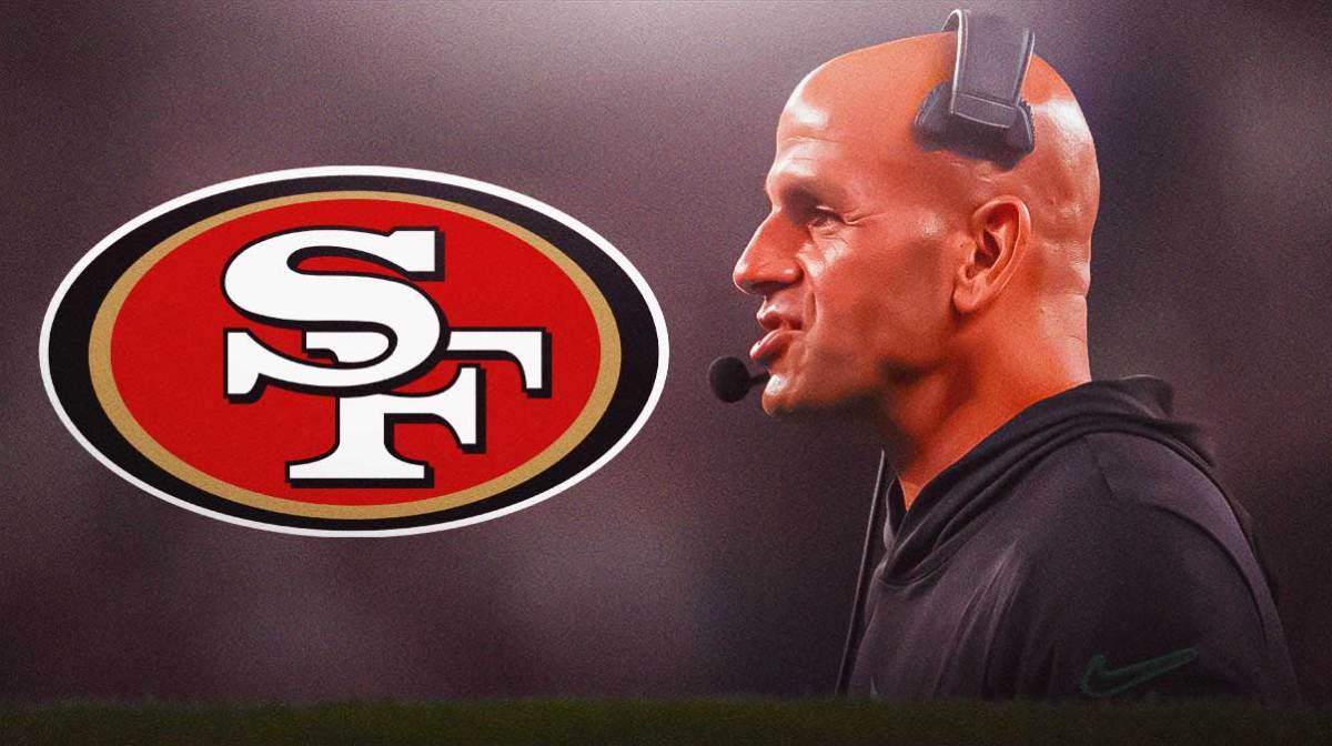 Robert Saleh with the San Francisco 49ers logo in the background.