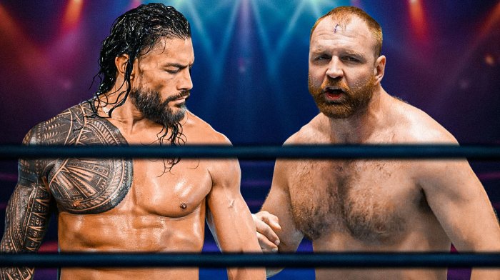 Roman Reigns next to Jon Moxley in a wrestling ring.