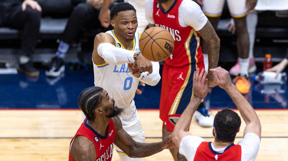 Los Angeles Lakers Guard Russell Westbrook (0) Passes the ball across New Orleans Pelican Pretri Larry Nance Jr. (22) and front of the Marshall (8) during the second half at the SMOOTHIE KING CENTER Center.