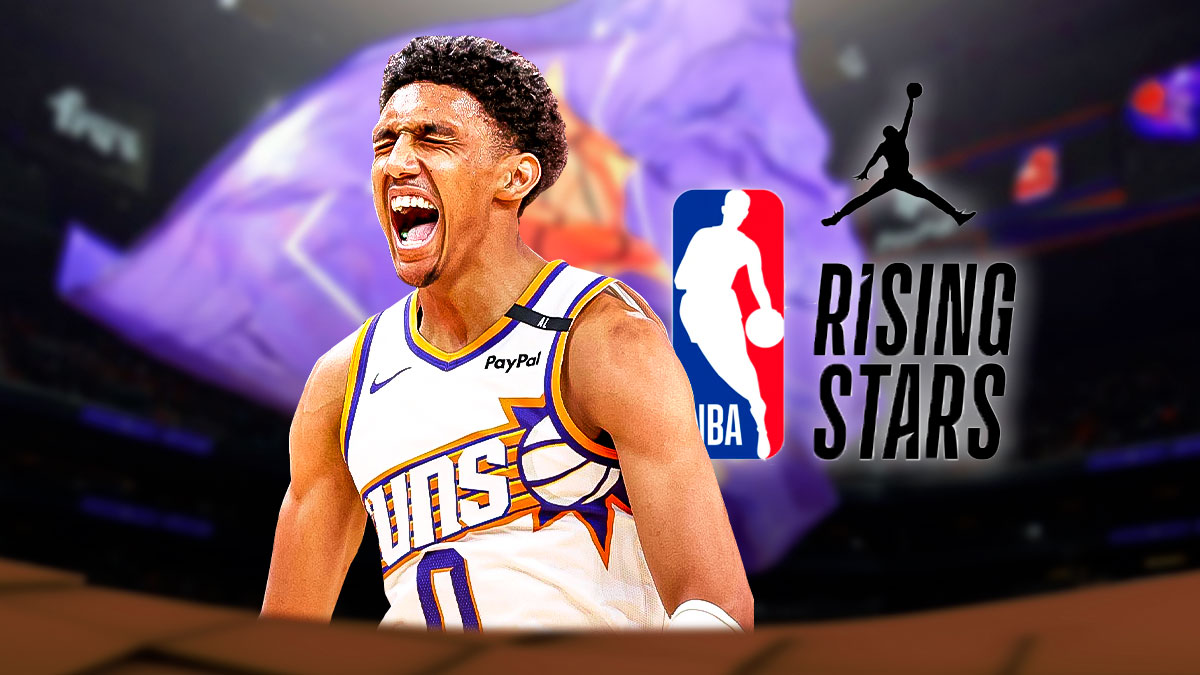 Suns forward Ryan Dunn looking hyped, with the NBA Rising Stars logo in the background, as well as a background of Downtown San Francisco.