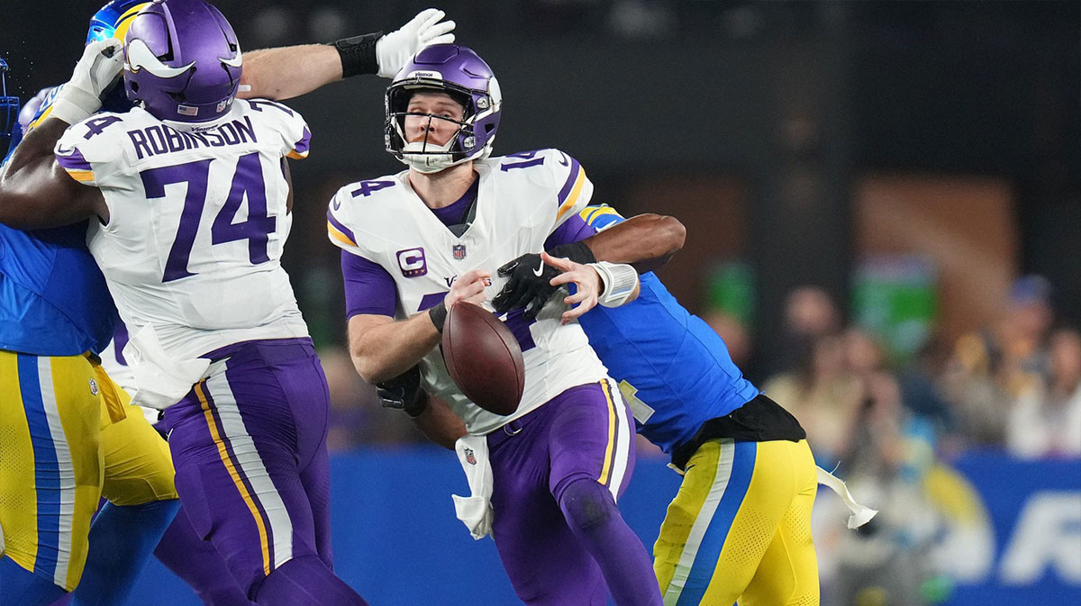 Minnesota Vikings quarterback Sam Darnold (14) fumbles the ball as he is sacked by Los Angeles Rams cornerback Ahkello Witherspoon (4) during their playoff game at State Farm Stadium on January 13, 2025 in Glendale.