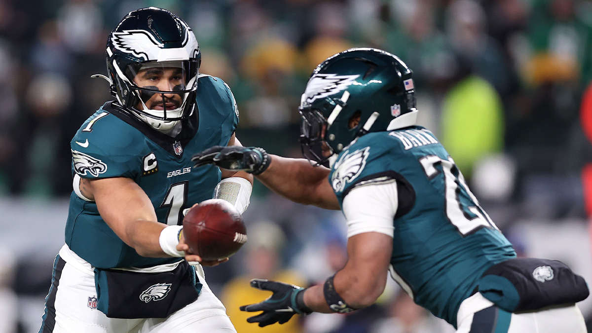 Philadelphia Eagles quarterback Jalen Hurts (1) hands the ball off to running back Saquon Barkley (26) during the third quarter in an NFC wild card game at Lincoln Financial Field.
