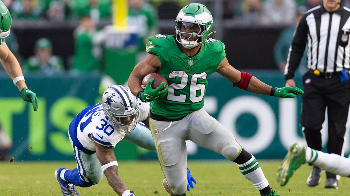 Philadelphia Eagles running back Saquon Barkley (26) runs with the ball past Dallas Cowboys safety Juanyeh Thomas (30) at Lincoln Financial Field.