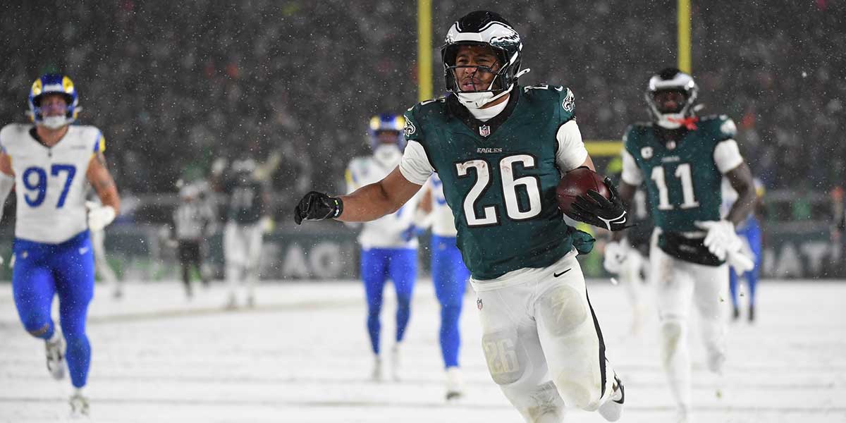 Jan 19, 2025; Philadelphia, Pennsylvania, USA; Philadelphia Eagles running back Saquon Barkley (26) carries the ball to score a touchdown against the Los Angeles Rams in the second half in a 2025 NFC divisional round game at Lincoln Financial Field. Mandatory Credit: Eric Hartline-Imagn Images