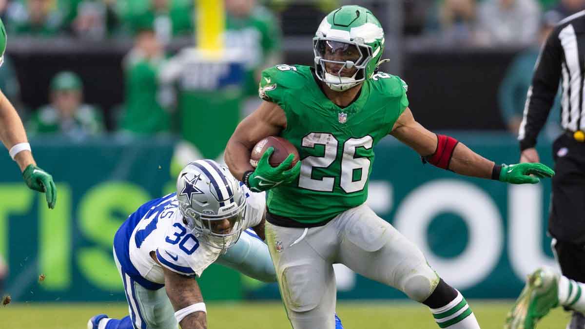 Philadelphia Eagles running back Saquon Barkley (26) runs with the ball past Dallas Cowboys safety Juanyeh Thomas (30) at Lincoln Financial Field.