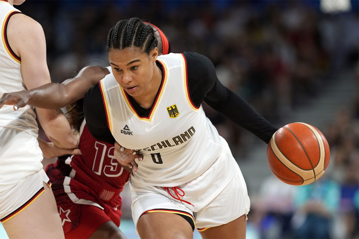 Germany forward Satou Sabally (0) controls the ball against United States guard Jackie Young (13) in the second half in a women’s group C game during the Paris 2024 Olympic Summer Games at Stade Pierre-Mauroy. 