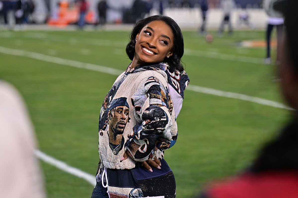 United States gymnast Simone Biles poses for a photo on the sidelines before the game between the Chicago Bears and the Seattle Seahawks at Soldier Field.