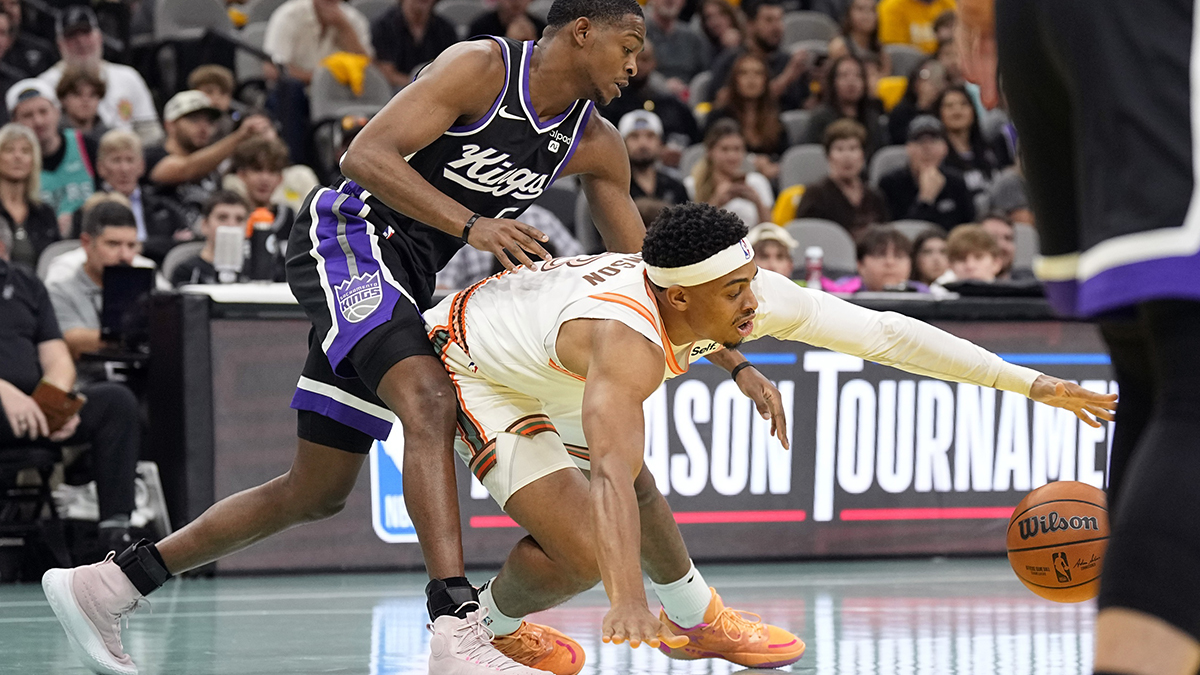 Sacramento Kings Guard De'Aaron Fok (5) and San Antonio Spurs Forward Keldon Johnson (3) Battle for a loose ball during the first half in the Frost Bank Centura. 