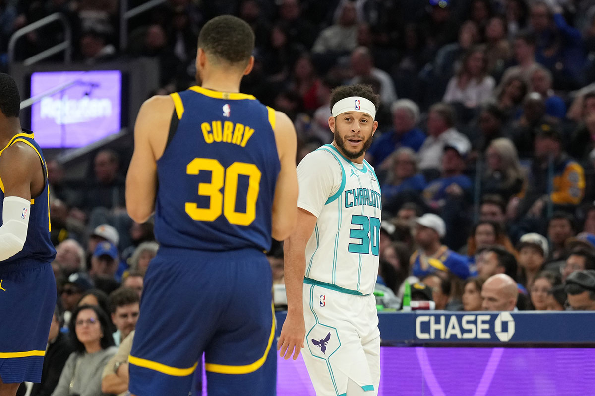 Charlotte Hornets guard Seth Curry (right) talks with Golden State Warriors guard Stephen Curry (left) during the fourth quarter at Chase Center.