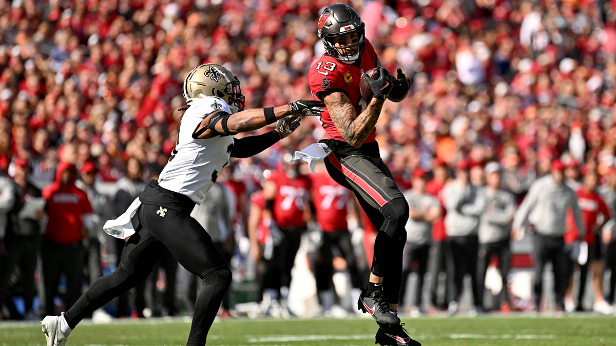 Tampa Bay Buccaneers wide receiver Mike Evans (13) catches the ball as New Orleans Saints defensive back Jordan Howden (31) looks to make the tackle in the first half at Raymond James Stadium.