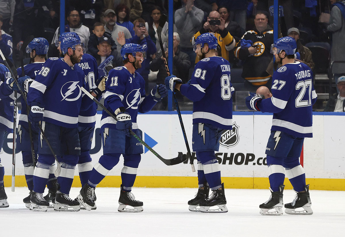 Tampa Bay Lightning center Luke Glendening (11), Tampa Bay Lightning defenseman Erik Cernak (81), Tampa Bay Lightning defenseman Ryan McDonagh (27) and teammates celebrate after they beat the Boston Bruins at Amalie Arena.