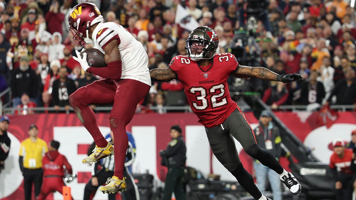 January 12, 2025; Tampa, Florida, USA; Washington Commanders wide receiver Terry McLaurin (17) catches a touchdown against Tampa Bay Buccaneers tight end Josh Hayes (32) during the fourth quarter of the NFC wild card playoffs at Raymond James Stadium. Mandatory Credit: Nathan Rai Seebeck-Imagn