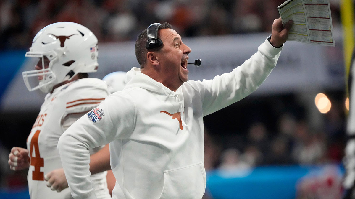 Texas head coach Steve Sarkisian directs his player against Arizona State during the second quarter of the Chick-fil-A Peach Bowl