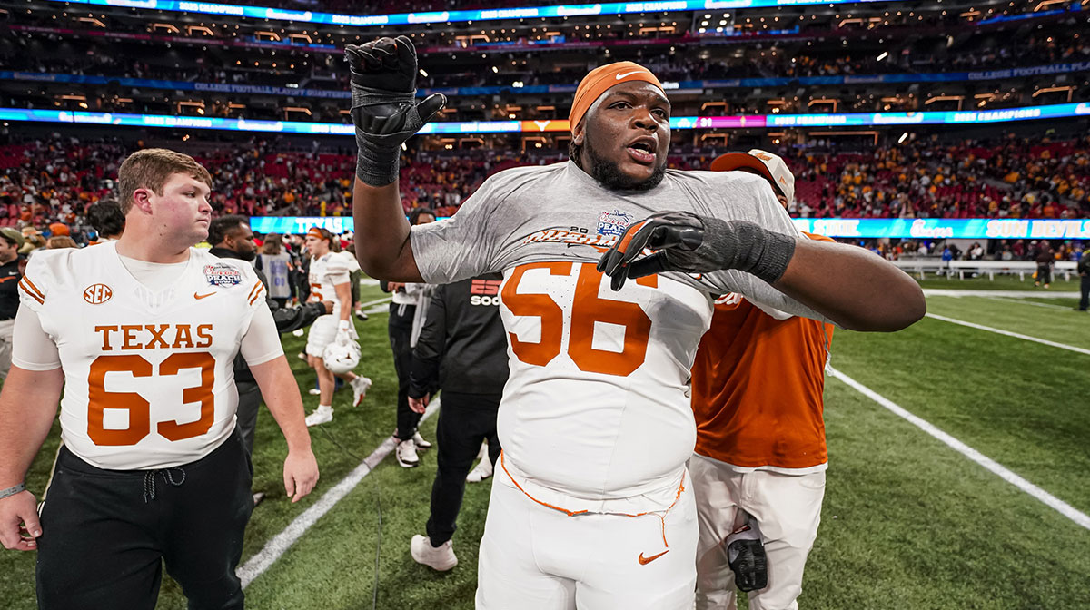 Texas Longhorns offensive lineman Cameron Williams (56) reacts as he gets a champions shirt for the Peach Bowl after Texas defeated the Arizona State Sun Devils in the second overtime at Mercedes-Benz Stadium.