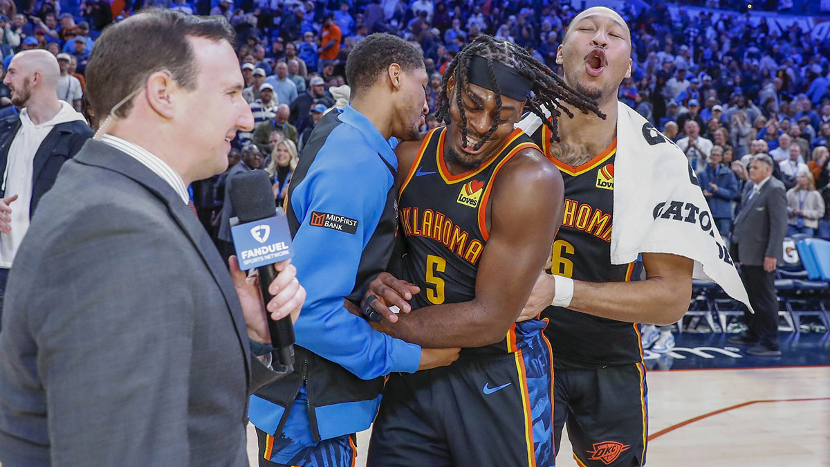 Thunder guard Luguentz Dort (5) celebrates with teammates guard Aaron Wiggins (21) and forward Jaylin Williams (6) after defeating the Boston Celtics at Paycom Center