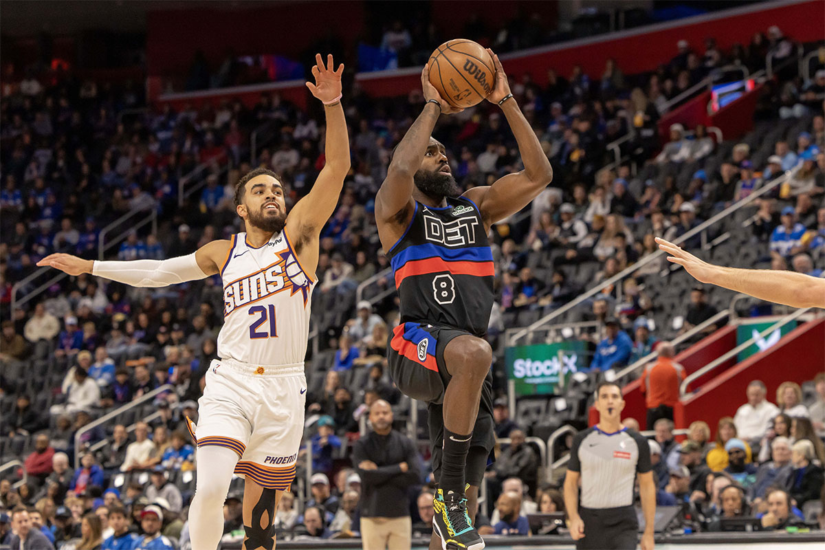 January 18, 2025; Detroit, Michigan, USA; Detroit Pistons forward Tim Hardaway Jr. (8) drives to the basket in front of Phoenix Suns guard Tyus Jones (21) during the first quarter at Little Caesars Arena.