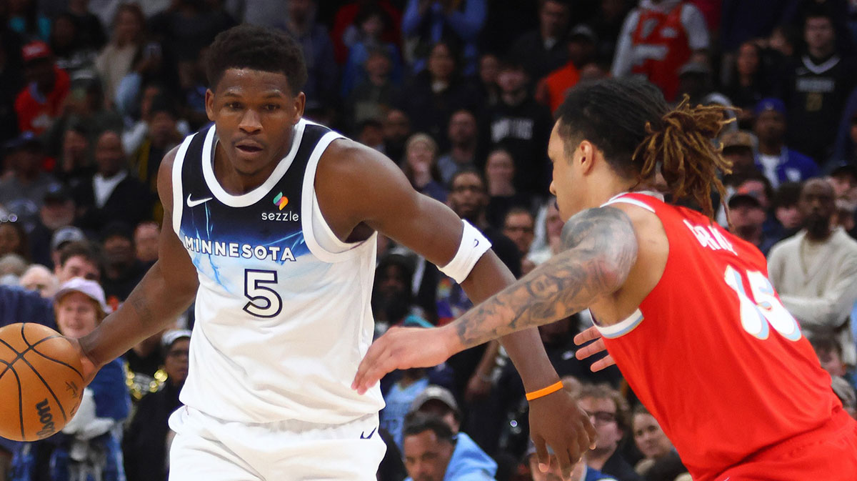 Minnesota Timberwolves guard Anthony Edwards (5) dribbles as Memphis Grizzlies forward Brandon Clark (15) defends during the fourth quarter at FedExForum. 