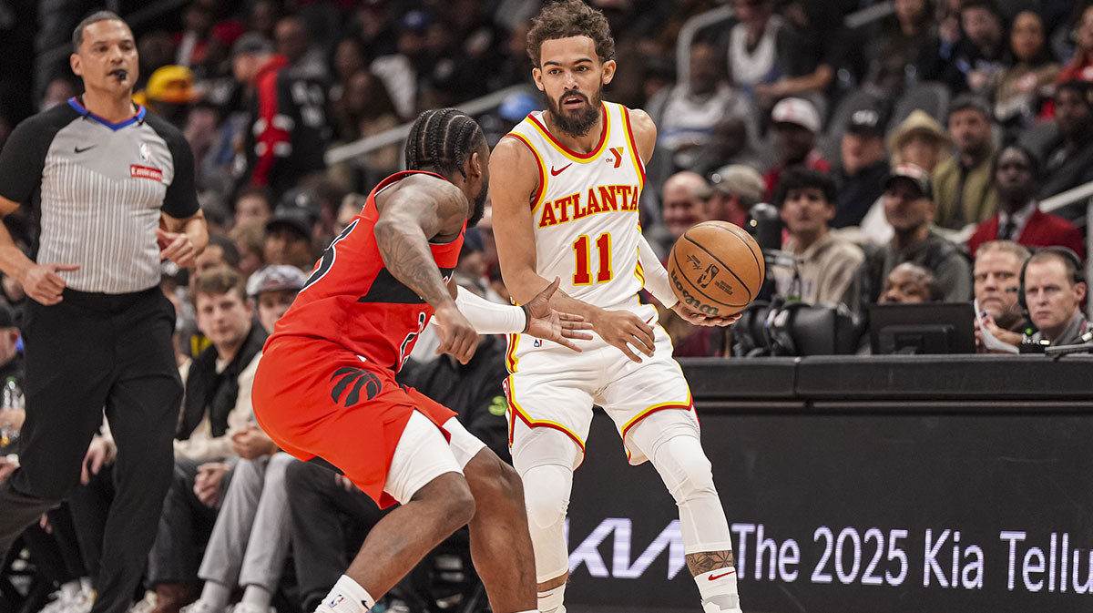 Atlanta Hawks guard Trae Young (11) dribbles against Toronto Raptors guard Jamal Shead (23) during the first half at State Farm Arena.