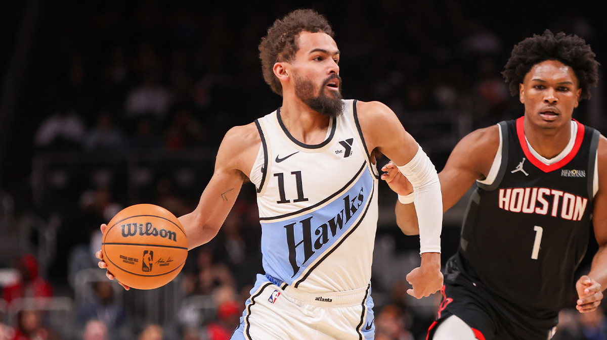 Atlanta Hawks Guard Trae Young (11) Dumpled Houston Rockets Next Amen Thompson (1) in the first quarter at the State Farm Arena.