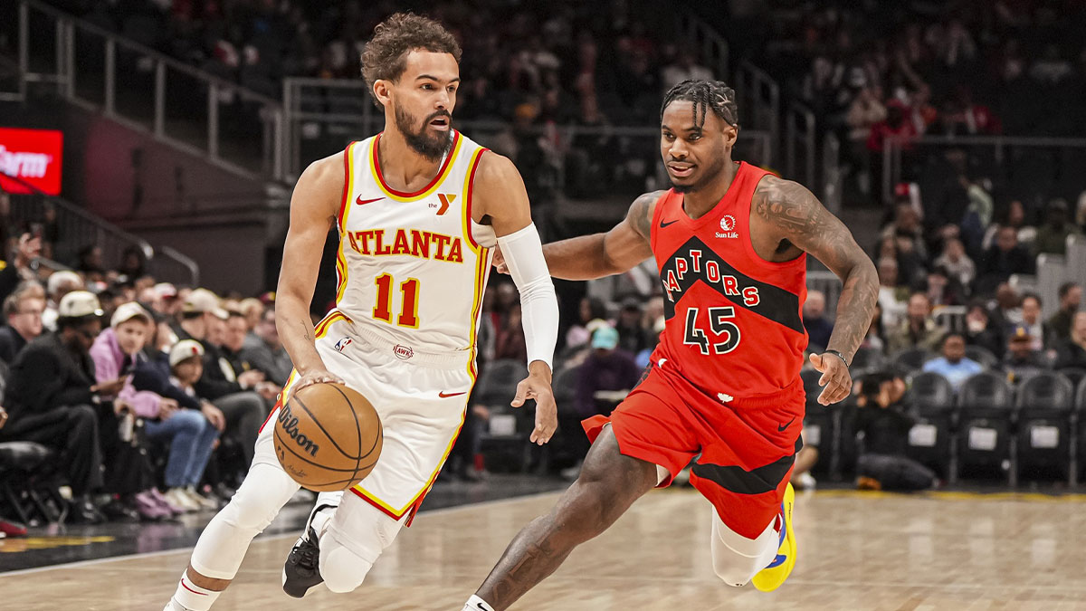 Atlanta Hawks guard Trae Young (11) drives the ball past Toronto Raptors guard Davion Mitchell (45) during the first half at State Farm Arena.