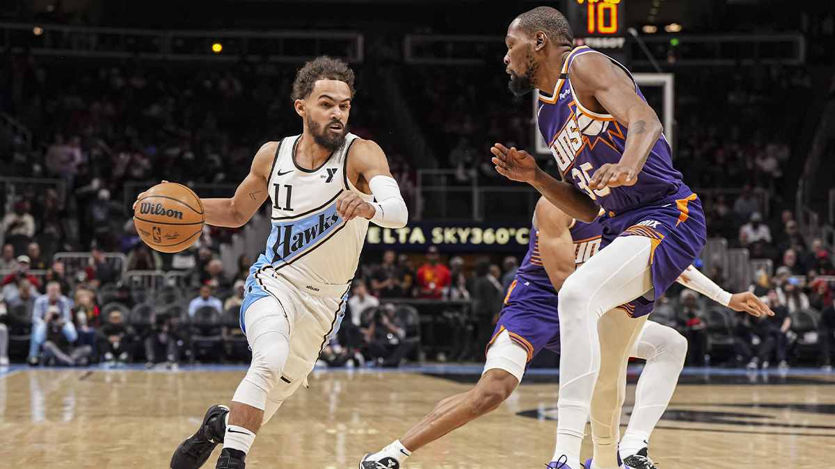 Atlanta Hawks guard Trae Young (11) dribbles against Phoenix Suns forward Kevin Durant (35) during the first half at State Farm Arena.