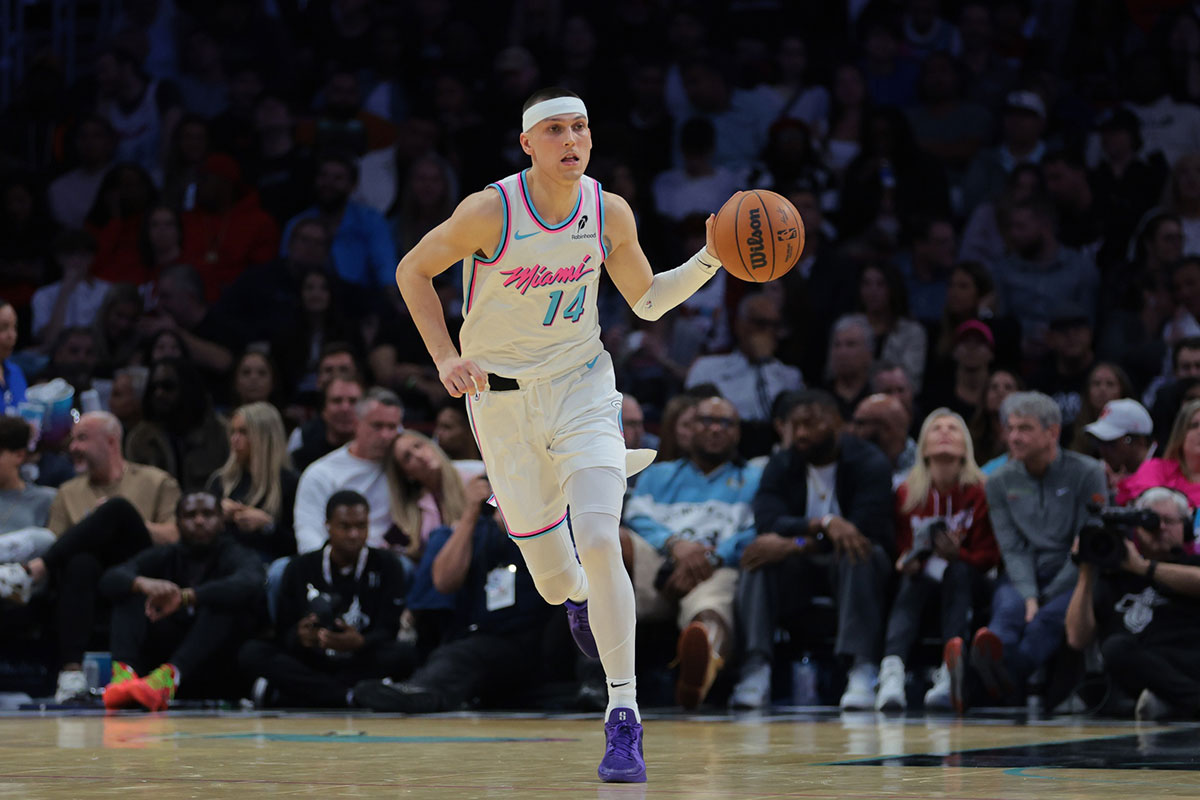 Miami Heat guard Tyler Herro (14) dribbles the basketball against the Denver Nuggets during the fourth quarter at Kaseya Center.