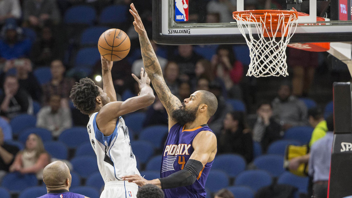 Phoenix Suns center Tyson Chandler (4) jumps up in attempt to block a shot from Minnesota Timberwolves forward Andrew Wiggins (22) in the second half at Target Center. The Timberwolves won 115-108.