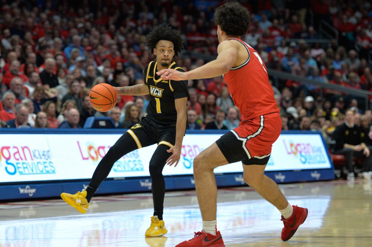 Virginia Commonwealth Rams guard Jason Nelson (1) battles against Dayton Flyers forward Nate Santos (2) during the first half of the game at University of Dayton Arena.