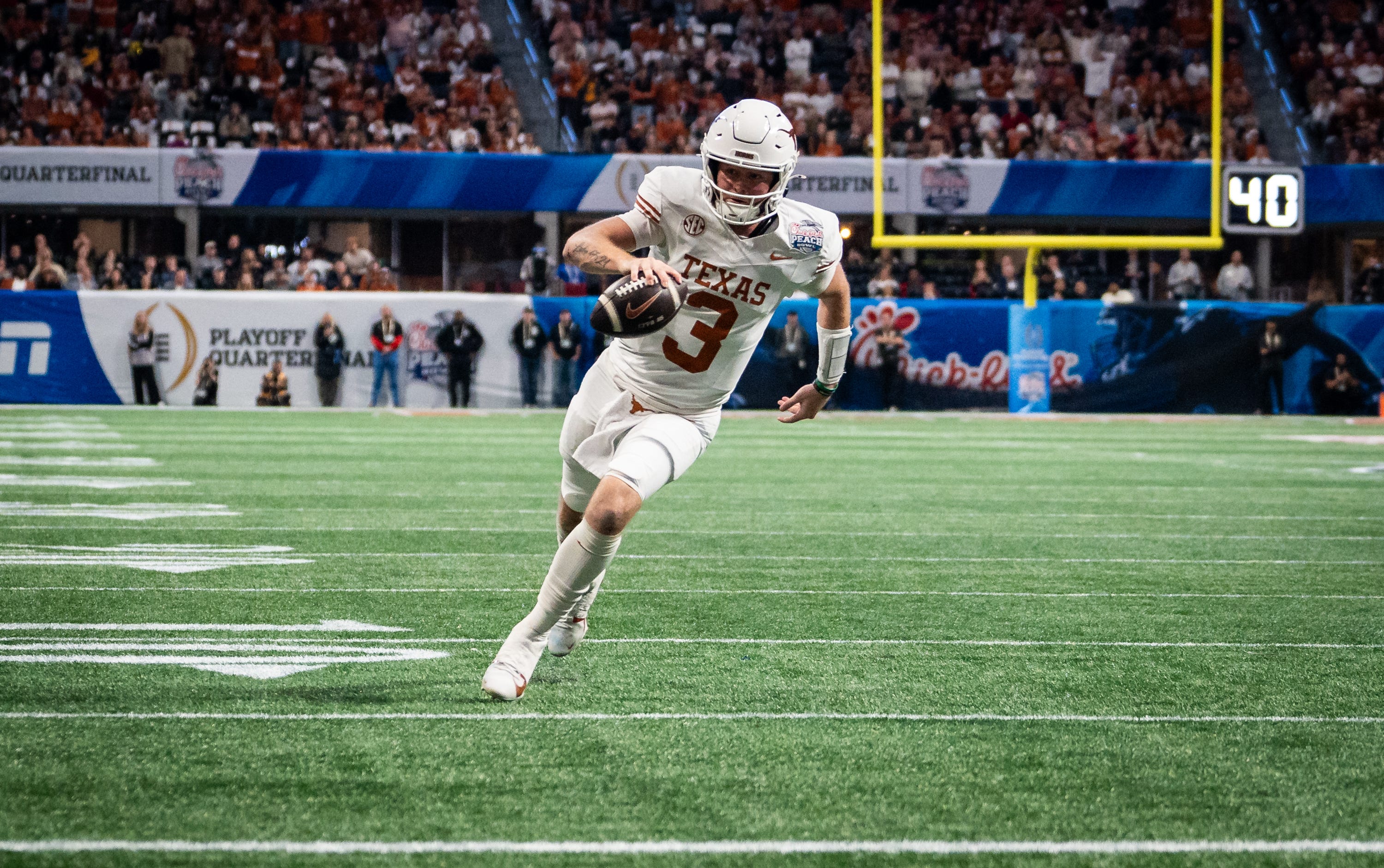 Texas Longhorns quarterback Quinn Ewers (3) runs the ball in to score a touchdown in the fourth quarter as the Texas Longhorns play the Arizona State Sun Devils in the Peach Bowl College Football Playoff quarterfinal
