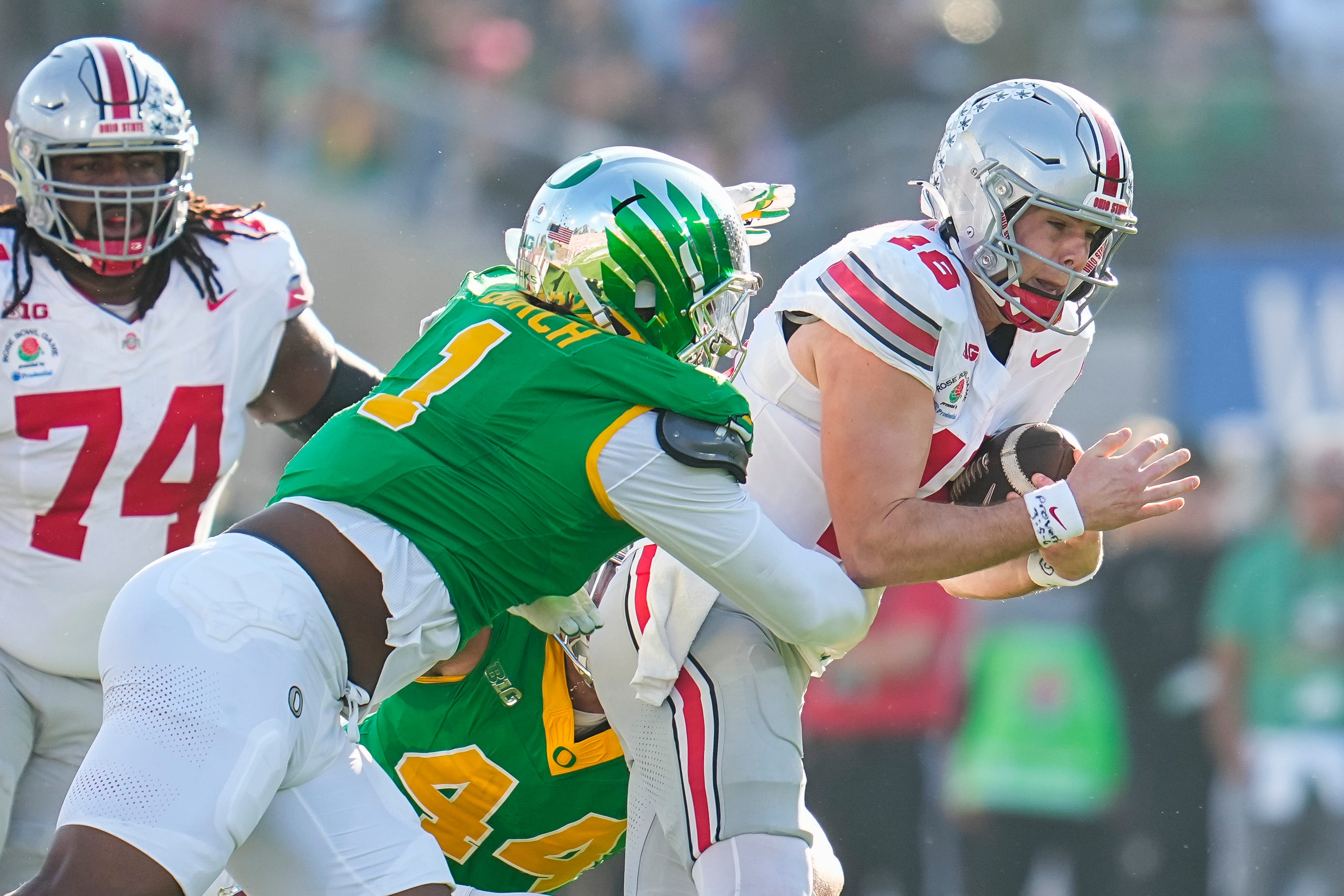 Ohio State Buckeyes quarterback Will Howard (18) runs through Oregon Ducks defensive end Jordan Burch (1) during the first half of the College Football Playoff quarterfinal at the Rose Bowl
