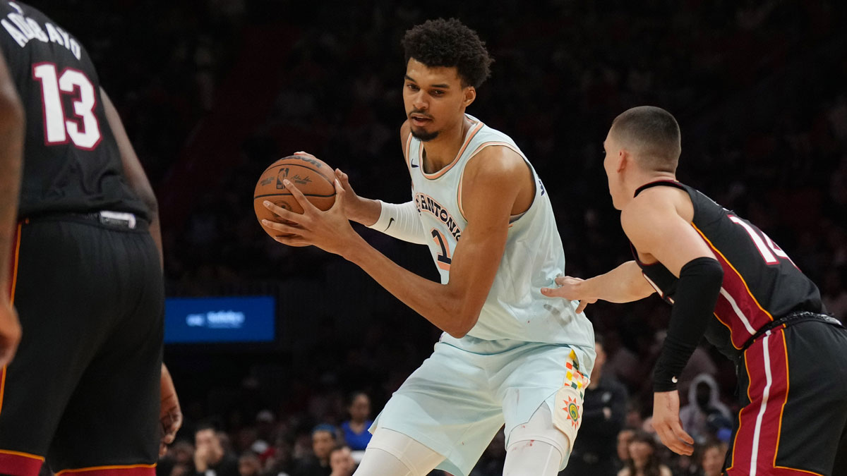 San Antonio Spurs center Victor Wembanyama (1) looks to pass the ball as Miami Heat guard Tyler Herro (14) defends during the first half at Kaseya Center. 