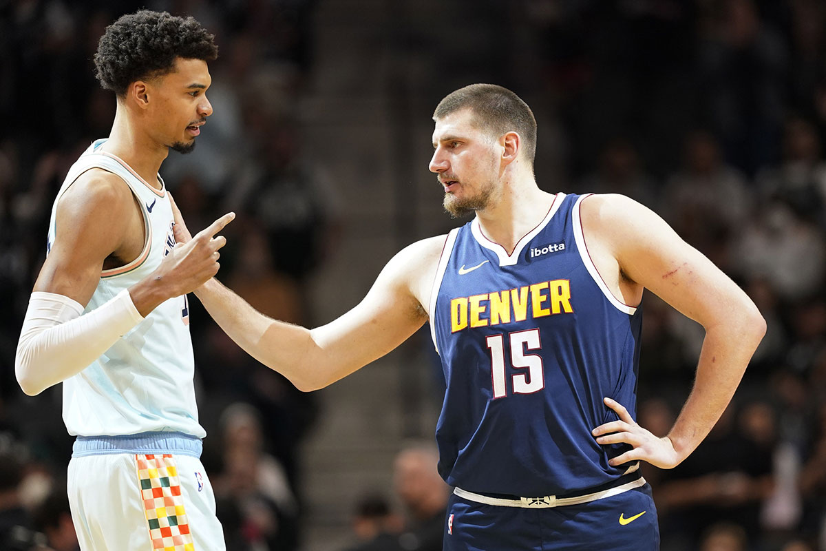 San Antonio Spurs center Victor Wembanyama (1) greets Denver Nuggets center Nikola Jokic (15) before a game at Frost Bank Center.