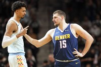 San Antonio Spurs center Victor Wembanyama (1) greets Denver Nuggets center Nikola Jokic (15) before a game at Frost Bank Center.
