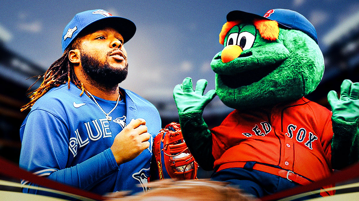 Vladimir Guerrero Jr. (BLUE JAYS) with the Boston Red Sox macot (Wally the Green Monster) in the background)