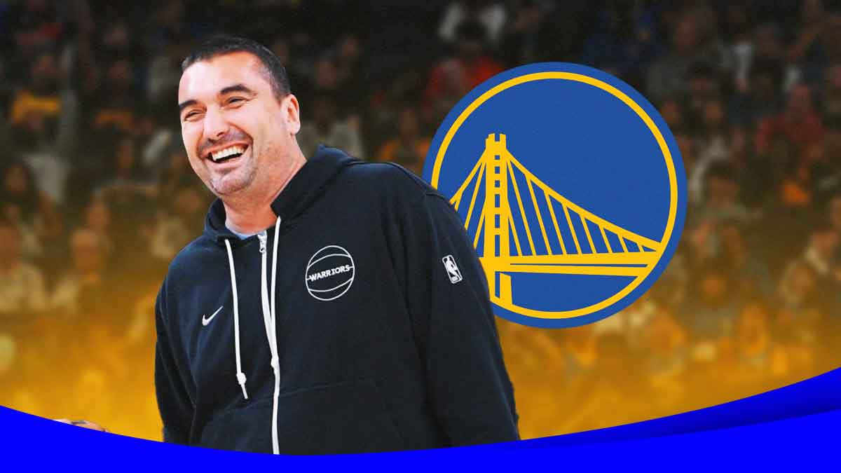 Dejan Milojevic with the Warriors logo in the background
