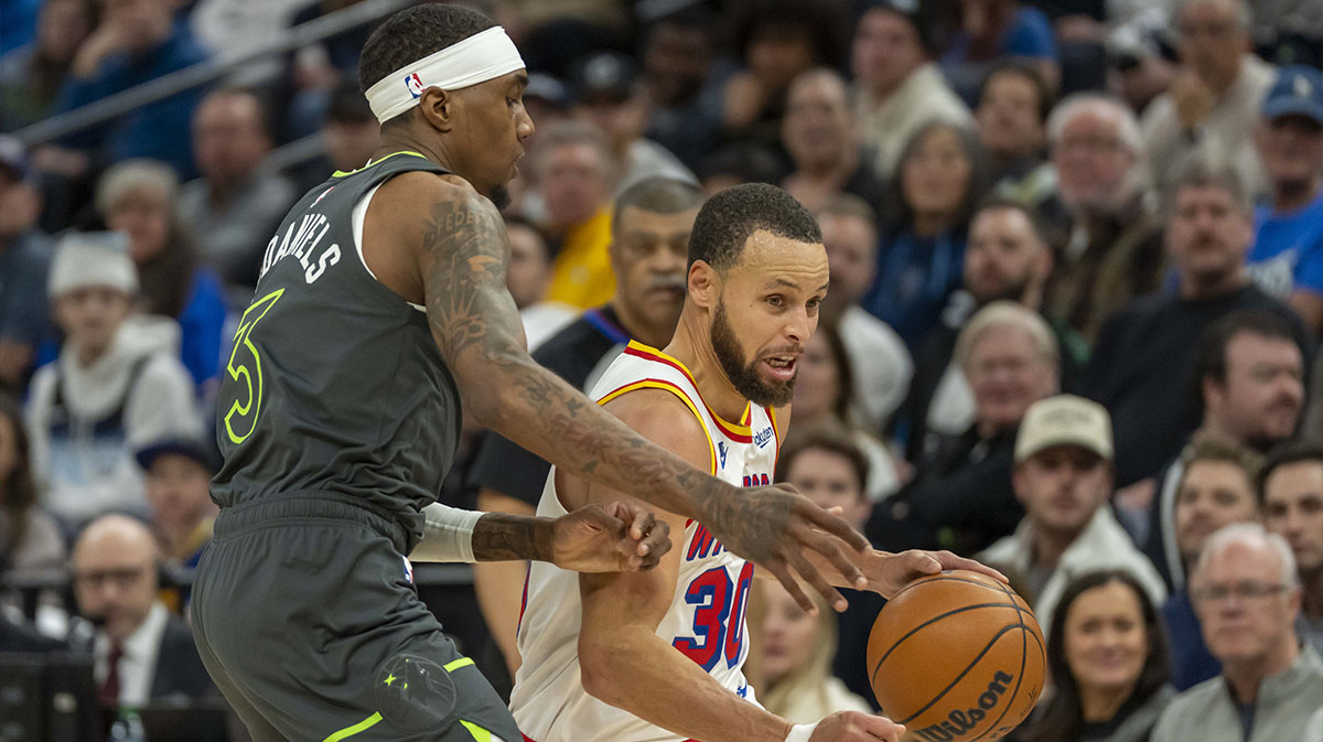 Warriors guard Stephen Curry (30) dribbles past Minnesota Timberwolves forward Jaden McDaniels (3) in the second half at Target Center