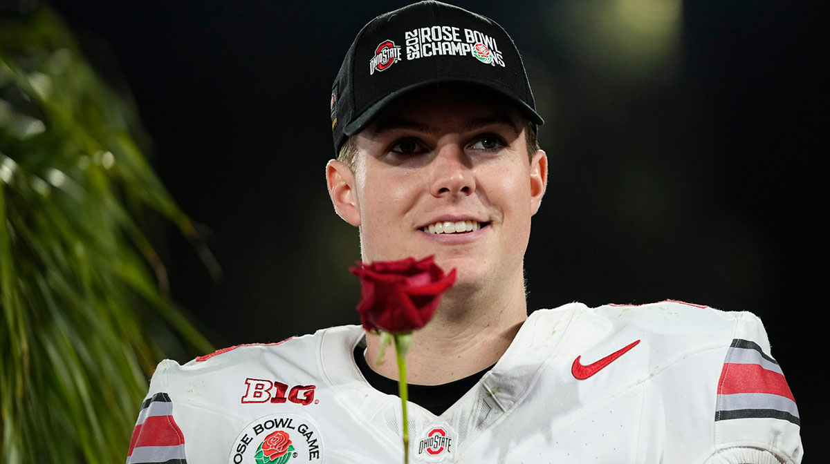 Ohio State Buckeyes quarterback Will Howard (18) holds a rose following the College Football Playoff quarterfinal against the Oregon Ducks at the Rose Bowl