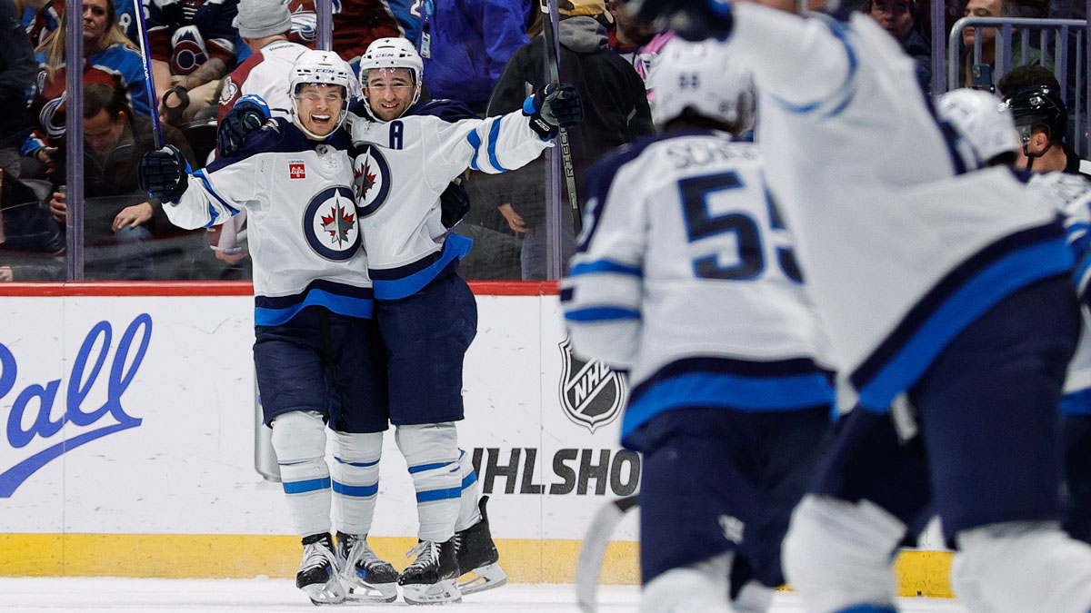 Winnipeg Jets defenseman Neal Pionk (4) celebrates his goal with center Vladislav Namestnikov (7) in overtime against the Colorado Avalanche at Ball Arena.