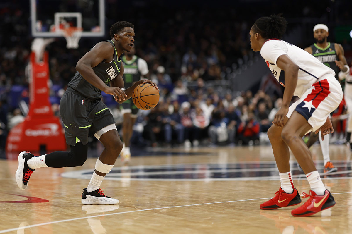 Minnesota Timberwolves guard Anthony Edwards (5) drives to the basket as Washington Wizards guard Bab Carrington (8) defends in the fourth quarter at Capital One Arena. 